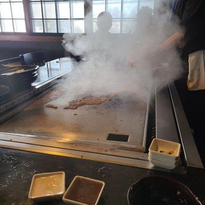 Chef cleaning the griddle