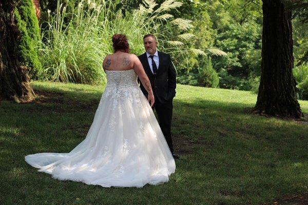 Bride and father first look outside on the hill side on the way up to the garden