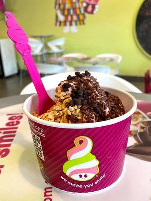 Chocolate, strawberry, tart frozen yoghurt with chocolate sprinkles, chocolate morsels and peanuts.