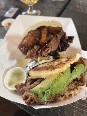 Top is Pabellon Arepa - shredded beef, black beans, cheese and plantains, bottom is Pulled Pork Arepa with Avocado.