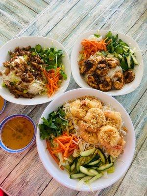 Two rice bowls - one with ginger soy chicken and the other with lemongrass shrimp. One noodle bowl with fried shrimp and fish sauce.