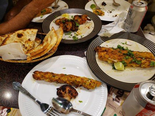 Chicken Bihari Kabobs (top center), Chicken Cheese Kabobs (right), and Sesame Naan (left).