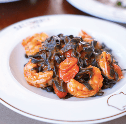 Fettuccine Nere: Black ink Fettuccine, wild caught shrimp, garlic, Calabrian chili oil, tomato sauce.