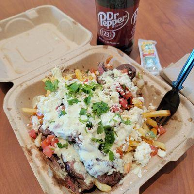 Asada Fries: Perfectly cooked & seasoned steak on a bed of fries with a fried jalapeño, pico, cilantro, cheese blend, & a lime crema!