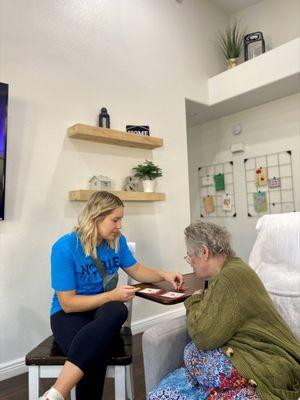 Noble Hospice volunteer playing board games with a patient.