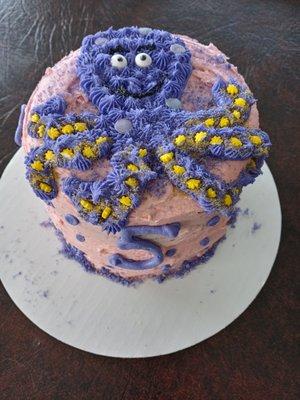 Purple octopus strawberry cake with strawberry icing.