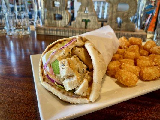 The Grilled Chicken Pita with Arugula, Red Onion, Tomatoes, Avocado, Mozzarella and Chipotle Mayo