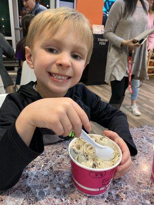 Someone loves their Oreo ice cream (with his three toppings in side bowl)