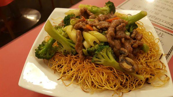 Beef and broccoli over pan fried noodles