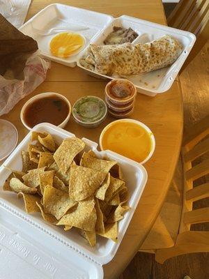 Veggie burrito and chips with queso, guac, and salsa