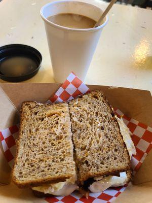 Fried eggs, cheddar, gouda and turkey bacon on whole grain toast. Coffee with espresso shot. Very good.