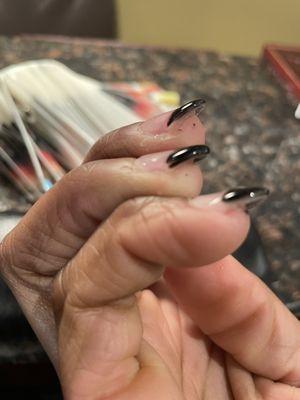 Nail polish on fingers and divots and big waves in four of ten nails.