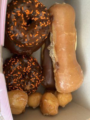 Halloween sprinkle donuts, donut holes, chocolate bar and custard filled bar.