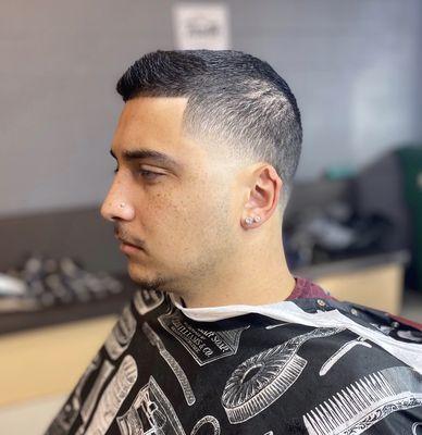 Short scissor cut with a high temple taper. Hair cut done by Our barber Jacob.