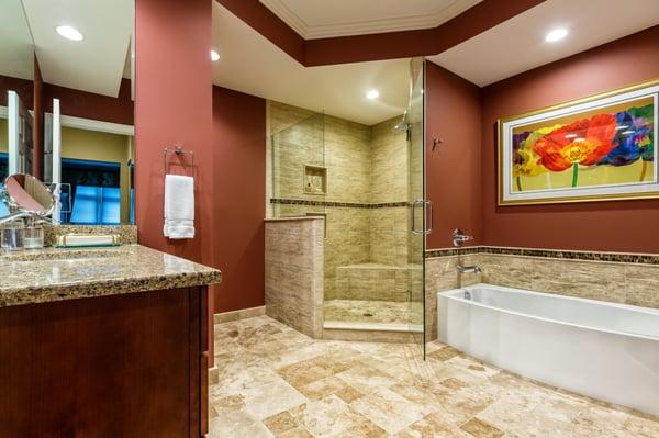 Beautiful remodel of a bathroom with walk in shower and featured tub.