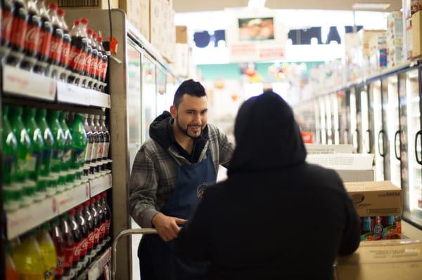 Grocer Mr. Valentin helping out a customer!