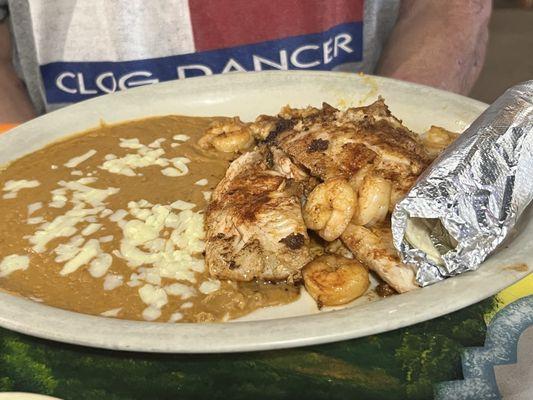 Tilapia with shrimp and refried beans.