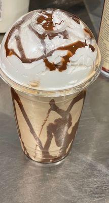 Coffee shake with chocolate drizzle and whipped cream