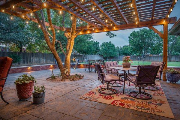 Beautiful outdoor living space including a stunning patio and pergola installation in Lubbock, TX!