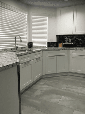 This kitchen got a splash of new cabinets and countertops because the old cabinets got damage by water.  Home owner is happy!