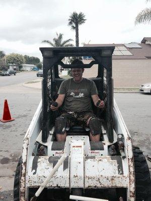 Having fun at work in the little tractor.