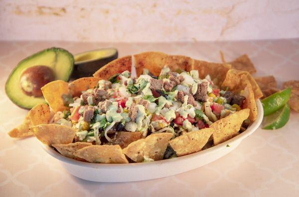 Bowl with a Nacho Base and our carne asada steak!