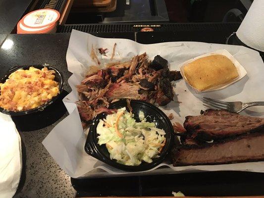 Pulled pork and brisket combo with corn bread and sides of mac and cheese and coleslaw.