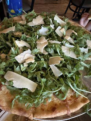 Prosciutto and Arugula pizza. Thin and stable crust and loaded with toppings. This is the small!