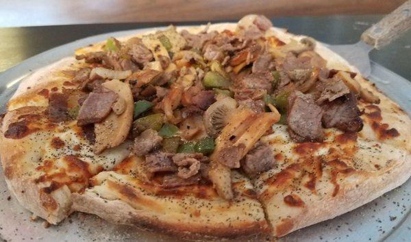 Solid Philly Cheesesteak Pizza with tons of toppings.