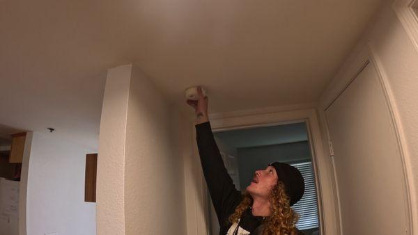 Jonny reinstalling a smoke detector after we finished working.