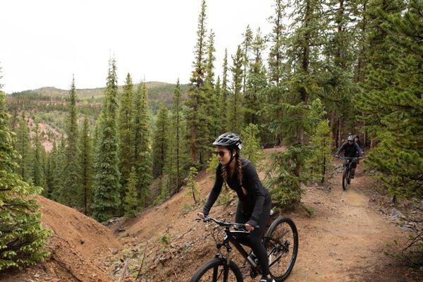 woman mountain biking in Summit County