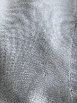 Next Cleaners not only smeared our shirts but also poke holes in one of them!