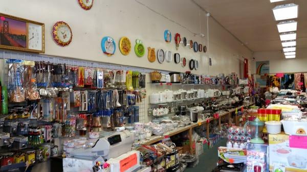 A wall of appliances, kitchen ware, Zojirushi thermoses, and cute little wall clocks.