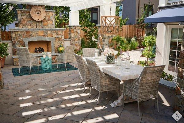 Al fresco dining patio featuring custom outdoor fireplace