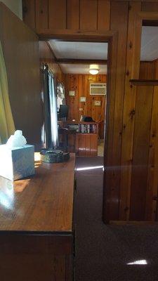 Cedar Cabin (view of bedroom drawers, living room, and kitchen from the entryway)