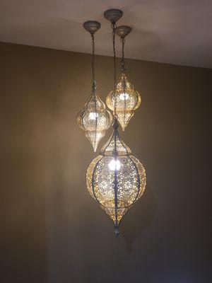 Staggered foyer chandeliers.