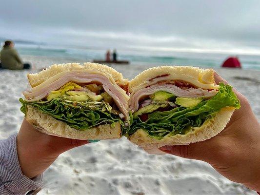 Cheersing sandwiches at the beach