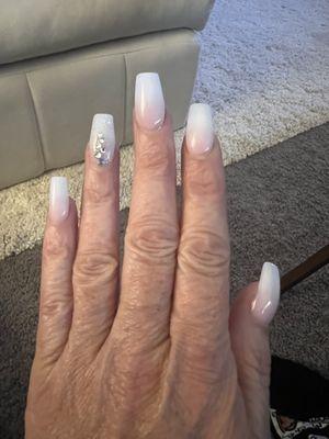 Pink-white tip ombre, coffin shape, medium length, with some bling on the ring finger. LVE my nails. They always do a great job.