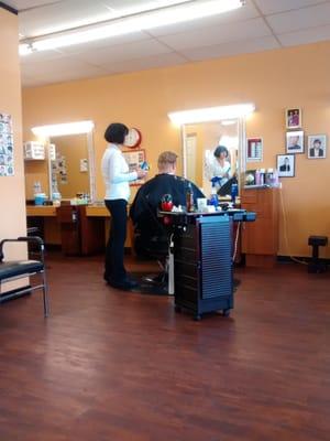 Angie hard at work. And Kris relaxing getting his hair cut finally.