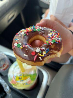 Chocolate glazed donut with sprinkles