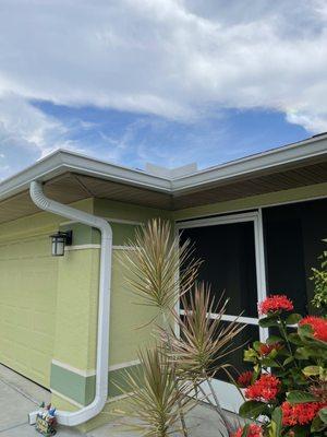 Pretty new gutters allow rain to drain off roof and go down the driveway instead of gushing all over.