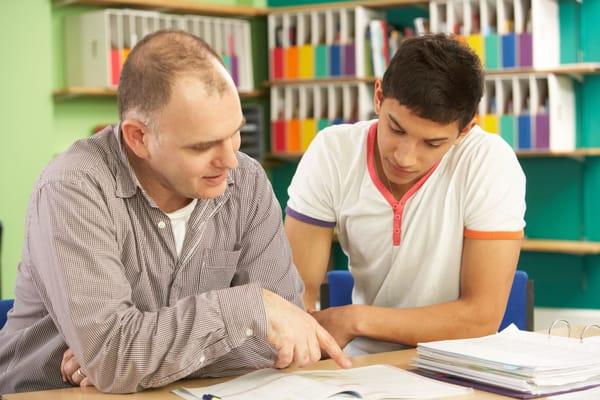 Focusing on improving his test scores with his tutor.