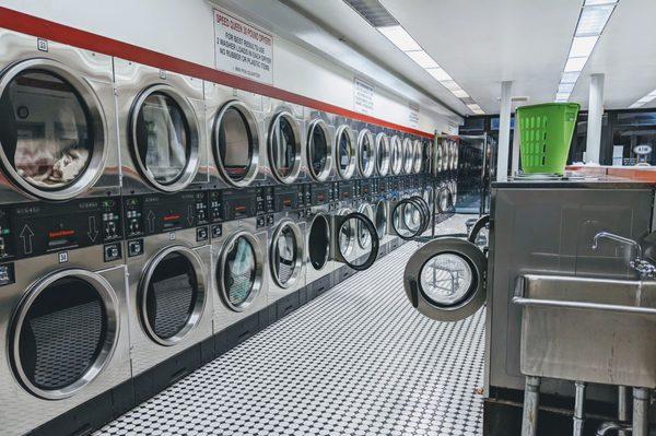 Row of dryers and smallest-sized front-loading washers.