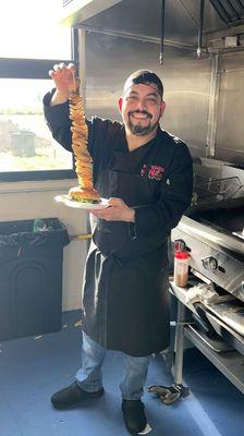 Chef Leo (Owner) holding our famous Katrina Burger