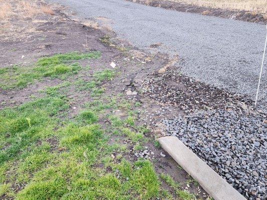 Improper drainage eroding lawn, driveway and curbing