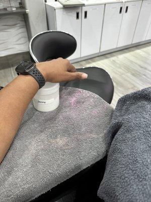 Photo of my wrist placed on top of gel powder cause the pedicure chair isn't designed for manicures to be completed there