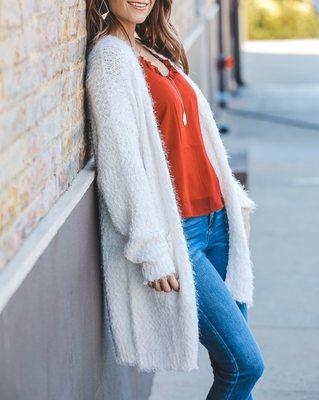 Cream cardigan, red tank and denim