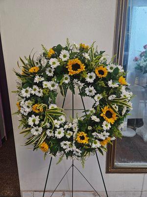 Granny's favorite flowers incorporated into a wreath standing spray