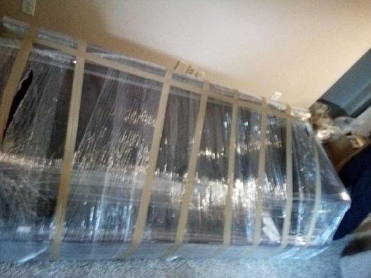 All furniture is padded with moving pads and shrink wrapped