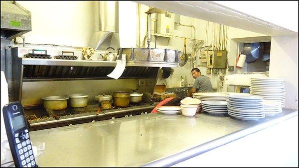 The chef seems a little surprised as I peek through the window to the kitchen and snap his photo.